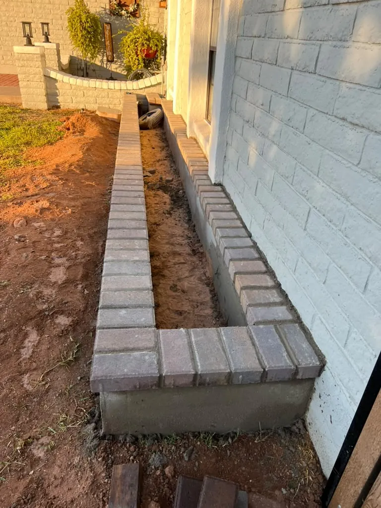 Side yard cleared and graded to clean gravel.