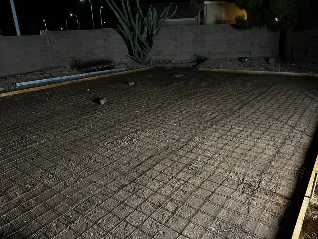 Finished paver patio in multi-tone brick, laid tight against the block wall